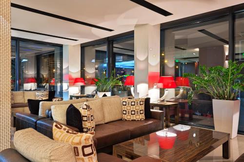 a living room with a couch and a table at Hotel Cubix in Braşov