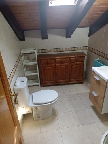 a bathroom with a toilet and a sink at nueva el bosquin in Nueva de Llanes