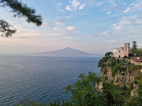 a building on a cliff next to the ocean at casa anna in Vico Equense