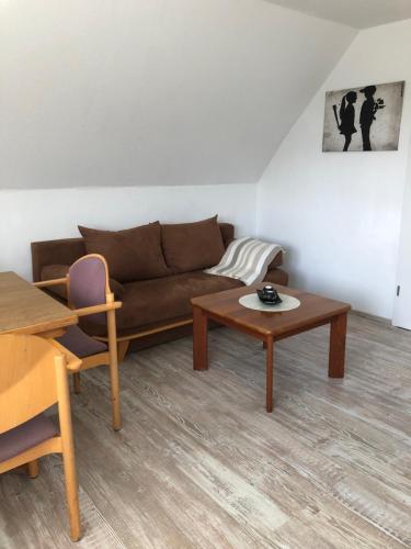 a living room with a couch and a table at Ferienwohnung Max in Rethwisch