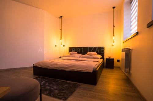 a bedroom with a bed with two pillows on it at Apartament Izabel in Nowy Targ