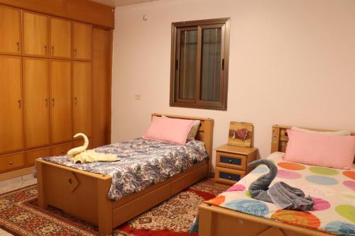 a bedroom with two twin beds and a mirror at Mreoma hostel in Majdal Shams