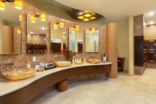 a bathroom with two sinks and two mirrors at Villa La Estancia Beach Resort & Spa Riviera Nayarit in Nuevo Vallarta