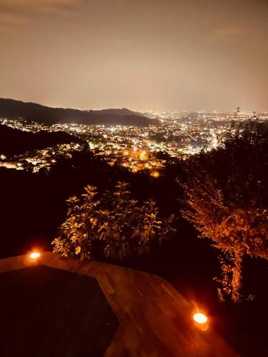 a view of a city at night with lights at LE LANTERNE in Villa dʼAlmè