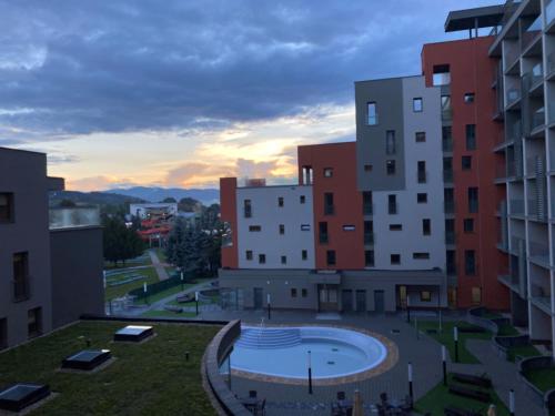 a view of a campus with buildings and a pool at Apartment Family Besenova - free pool in Bešeňová