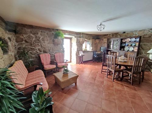 a living room with a couch and a table and chairs at Zimão Garden House in Vila Real