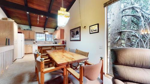 a kitchen with a wooden table and a dining room at Mammoth West #101 Condo in Mammoth Lakes