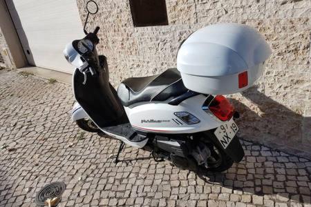 a white motor scooter parked next to a building at Room Atalaia - Bairro Alto in Lisbon