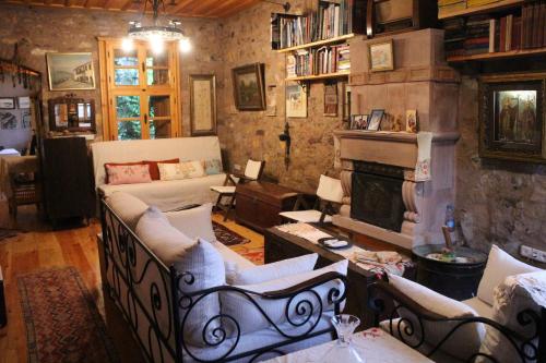 a living room with a couch and a fireplace at Stone House with Garden in Cunda/Ayvalik in Ayvalık