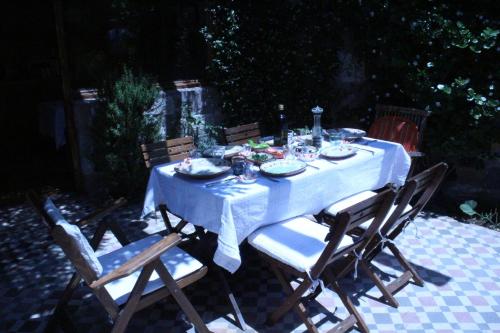 a table with a blue table cloth and chairs at Stone House with Garden in Cunda/Ayvalik in Ayvalık