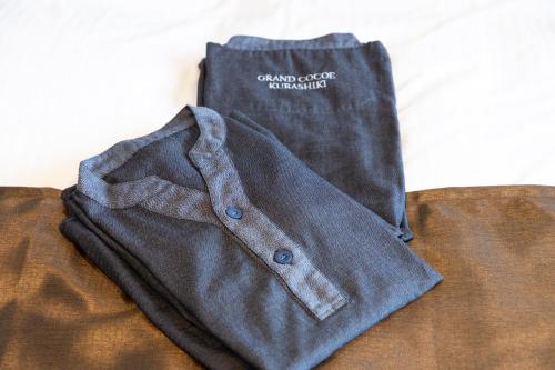 a cloth bag is sitting on top of a couch at Hotel Grand Cocoe Kurashiki in Kurashiki