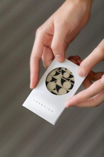 a person holding a piece of paper with a ball on it at Greet Inn in Kaohsiung