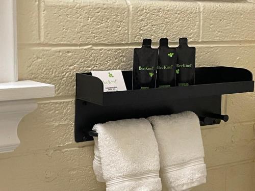 a black towel rack with bottles and towels on a wall at Historic Star Motel in Sedona