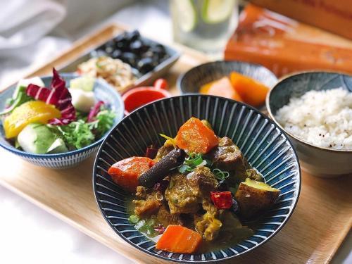 a table with bowls of food on a tray at Greet Inn in Kaohsiung