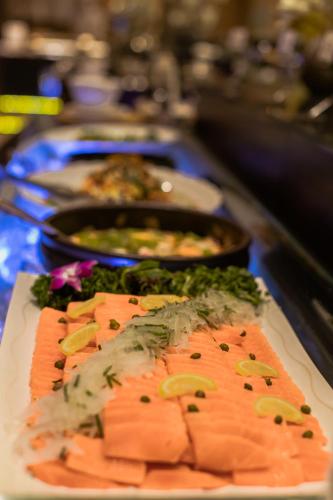 a buffet of food with salmon and other foods at Songdo Central Park Hotel in Incheon