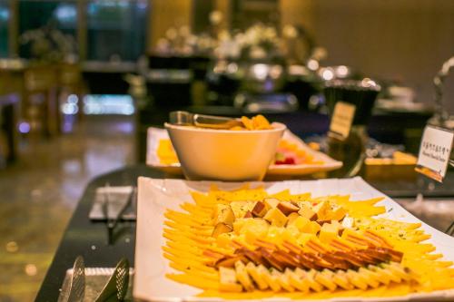 a plate of food on a table in a restaurant at Songdo Central Park Hotel in Incheon