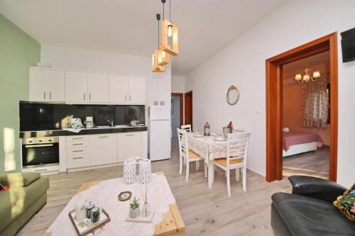 a living room with a table and a dining room at Koromilia Villa in Neo Klima