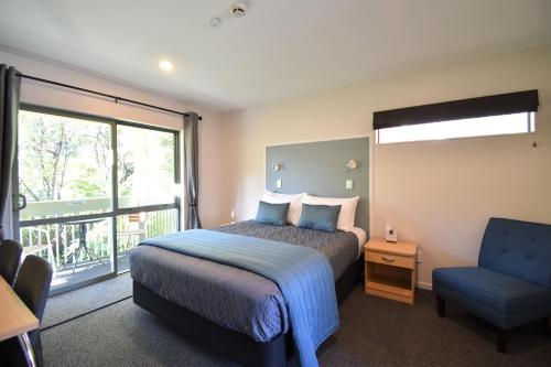 a hotel room with two beds and a television at La Rochelle Motel in Akaroa