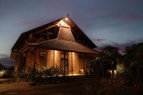 a house with a light on the side of it at Bhumi Kasuryan Borobudur in Borobudur
