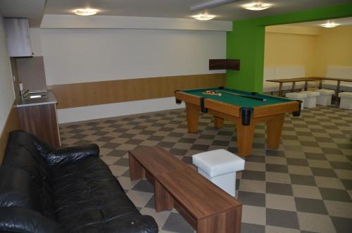 a waiting room with a pool table and a couch at Penzión NADKA in Bojnice