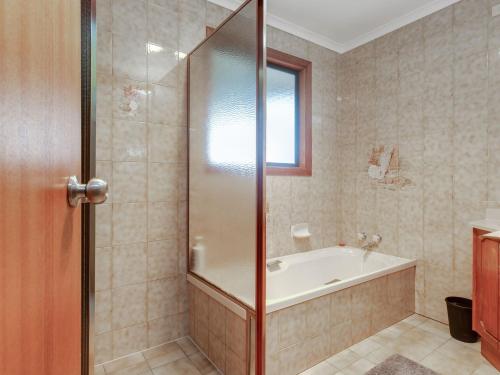 a bathroom with a bath tub and a shower at Lot 4 Retreat 150 Willson Drive in Normanville