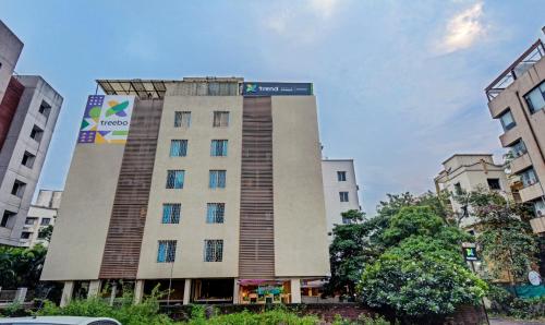 a building with a sign on the side of it at Treebo Trend Iris Suites in Pune