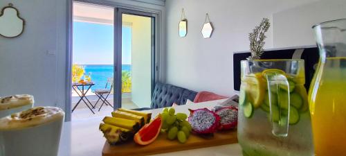 a kitchen counter with a cutting board with fruit in a vase at Phaedrus Living: Seaview Onyx Flat Lighthouse 48 in Paphos