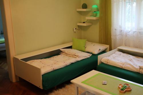a room with a bed and a couch and a table at Green Cactus Rooms - unique and cozy house in Senta