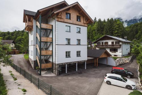 a white car parked in front of a building at Ferienwohnungen Villa Salzweg in Bad Goisern