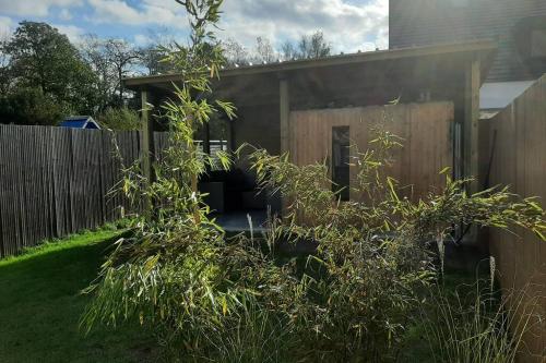 a backyard with a fence and a shed at De Blinker in Damme
