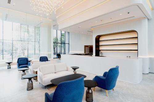 a lobby with blue chairs and a waiting room at Arbour Hotel and Residence in Pattaya Central