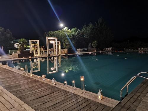 a swimming pool at night with lights in the water at Hotel Park Grumentum in Grumento Nova