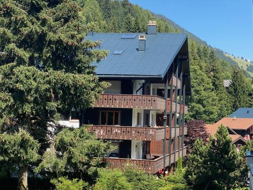 a large house with a solar roof on a mountain at 4 person apartment in central location in Morgins