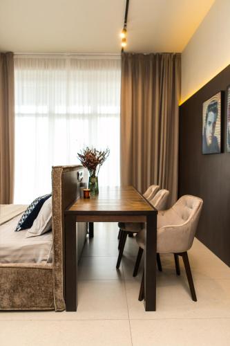a bedroom with a dining room table and a bed at Пентхауз с террасой район Мост Сити in Dnipro