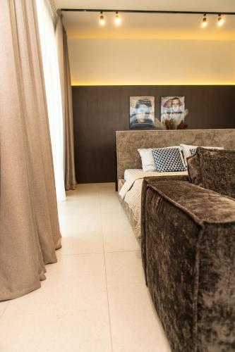 a bedroom with a large bed and curtains at Пентхауз с террасой район Мост Сити in Dnipro