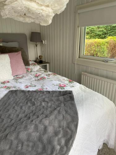 a bedroom with a large bed with a window at Bed&Breakfast M&M in Kungsbacka