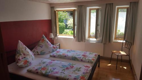 a small bedroom with a bed and two pillows at Haus Seehuber in Truchtlaching