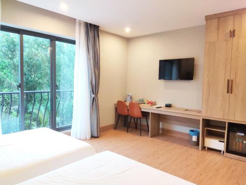 מיטה או מיטות בחדר ב-KHANG HOTEL CON DAO