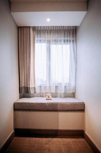 a bed in a room with a window at The Tytherington in Macclesfield