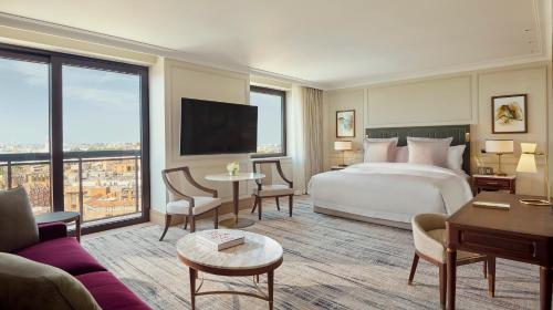 a hotel room with a bed and a large window at Jumeirah Carlton Tower London in London
