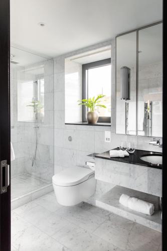 a bathroom with a toilet and a sink and a shower at 15 Basil Street Knightsbridge, Luxury Serviced Apartments in London
