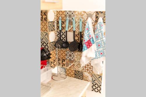 a kitchen with a bunch of utensils on a wall at ARGY’S HOME in Alexandroupoli