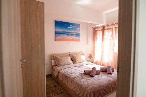 a bedroom with a bed with two pillows on it at ARGY’S HOME in Alexandroupoli