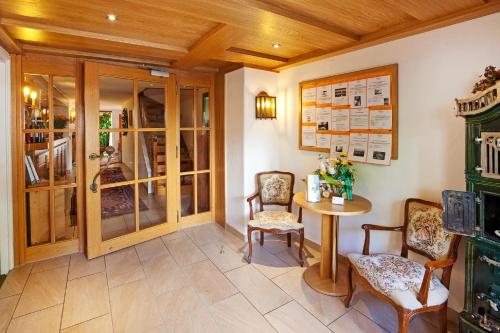 a dining room with a table and chairs and a table at Hotel Restaurant Frühlingsgarten in Füssen