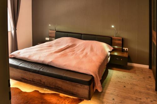 a bedroom with a bed with a black leather seat at Ferienwohnung Landsknecht in Volkach