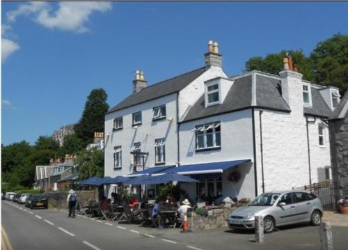 a large white building with a table outside of it at The Anchor Hotel in Kippford