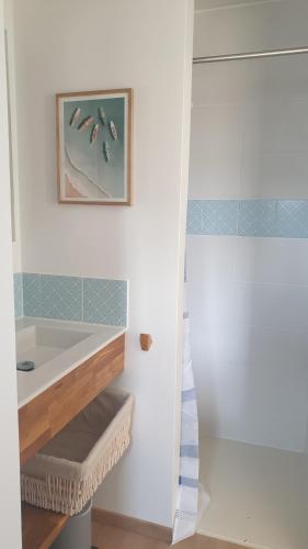 a bathroom with a sink and a bath tub at COSY T3 LACANAU in Lacanau
