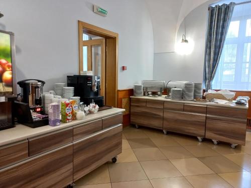 a restaurant with two counters with dishes on them at A-M Condominium in Veszprém