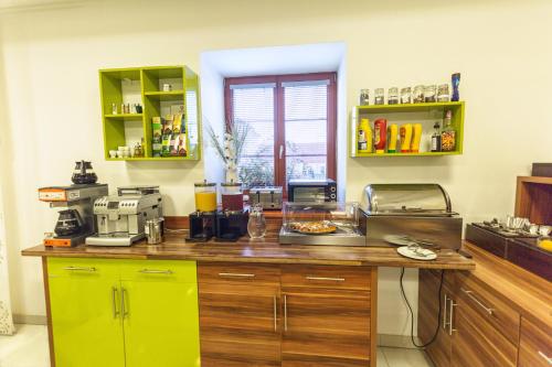 a kitchen with a counter with a yellow refrigerator at Golf&Wellness Resort Alfrédov in Alfrédov