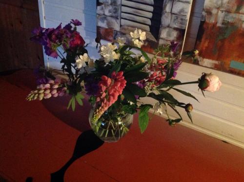 a vase filled with flowers on a table at Naboløs Rooms, near Munkebo, Kerteminde and Nyborg in Bovense